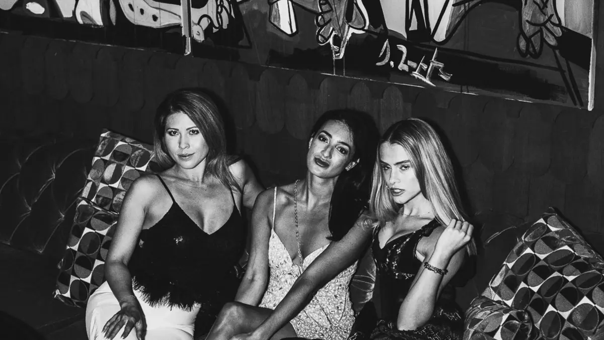 Gorgeous ladies sitting on velvet couches at Chicago's hottest cocktail lounge